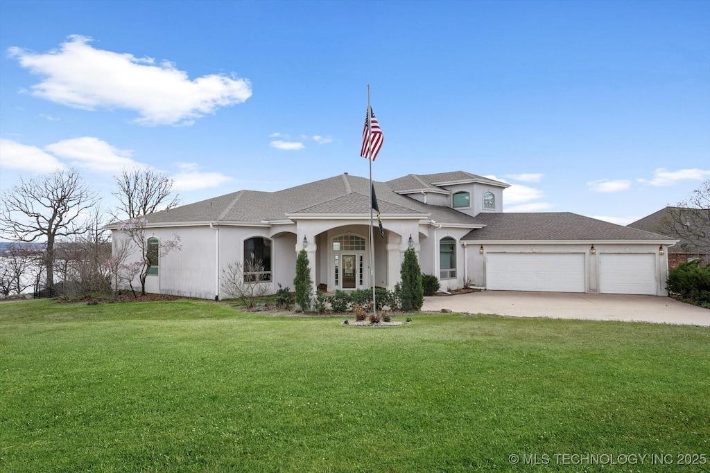 view of front of property featuring a front lawn, stucco siding, a garage, and concrete driveway