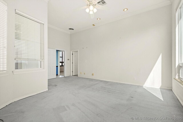 11746 Giorgio Dr, Skiatook, OK 74070 - spare room featuring crown molding, ceiling fan, light carpet, and visible vents