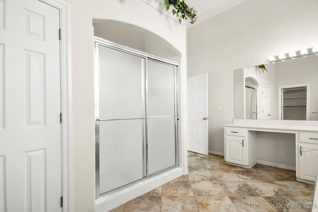 11746 Giorgio Dr, Skiatook, OK 74070 - bathroom with a stall shower, a closet, vanity, and baseboards