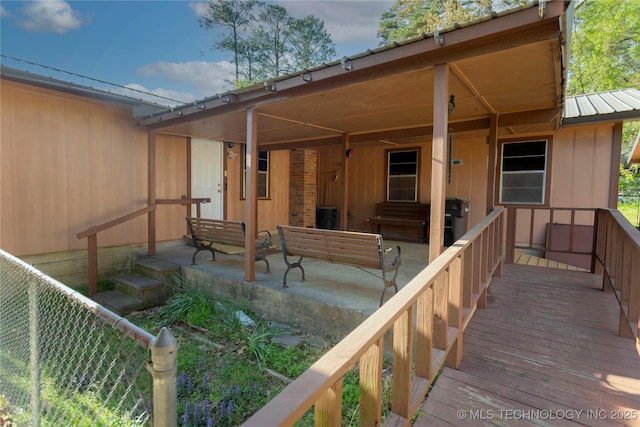 rear view of property featuring board and batten siding and metal roof