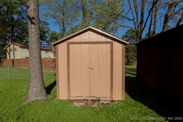 view of shed with fence