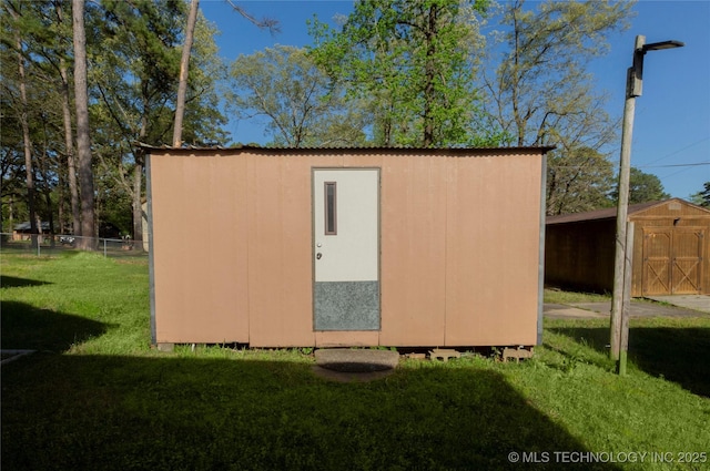 view of shed featuring fence