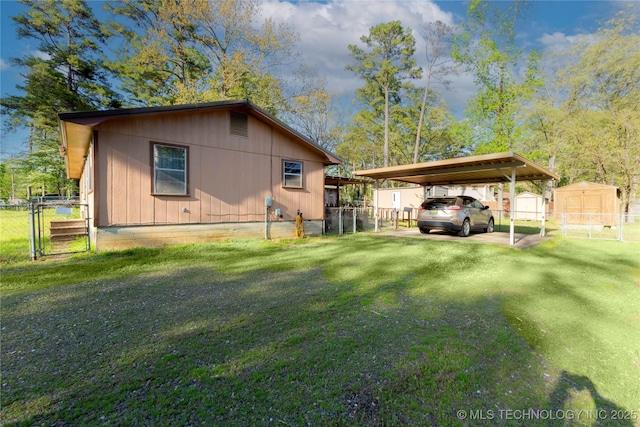 view of property exterior with a lawn, a detached carport, and fence