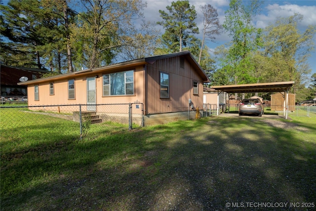 view of property exterior with a lawn, a detached carport, fence private yard, and crawl space