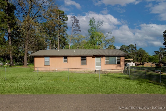 manufactured / mobile home featuring fence private yard, a front yard, and metal roof