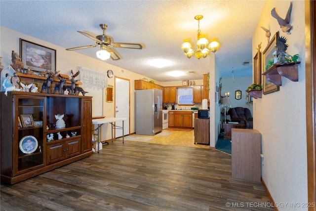 612 W Circle Dr, Broken Bow, OK 74728 - dining area featuring baseboards, light wood-style flooring, ceiling fan with notable chandelier, and a textured ceiling