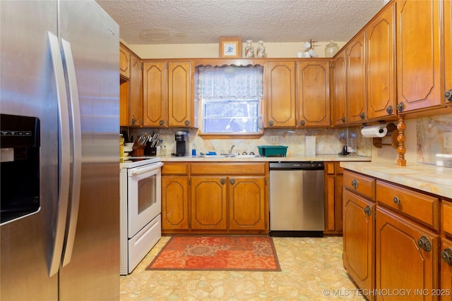 612 W Circle Dr, Broken Bow, OK 74728 - kitchen featuring appliances with stainless steel finishes, brown cabinets, light countertops, and a textured ceiling