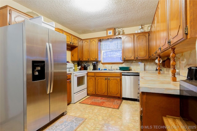 612 W Circle Dr, Broken Bow, OK 74728 - kitchen with appliances with stainless steel finishes, light floors, a textured ceiling, brown cabinetry, and tasteful backsplash