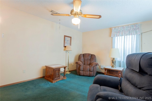 carpeted living room with visible vents, a textured ceiling, ceiling fan, and baseboards