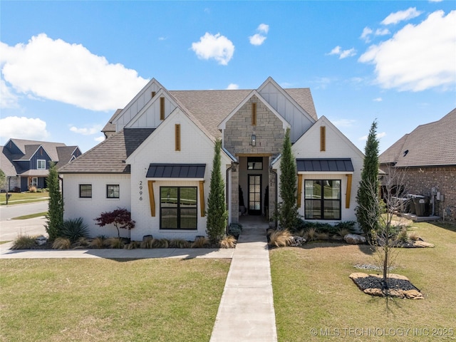 2996 E 142nd Ct S, Bixby, OK 74008 - modern farmhouse with a shingled roof, a standing seam roof, a front yard, and metal roof