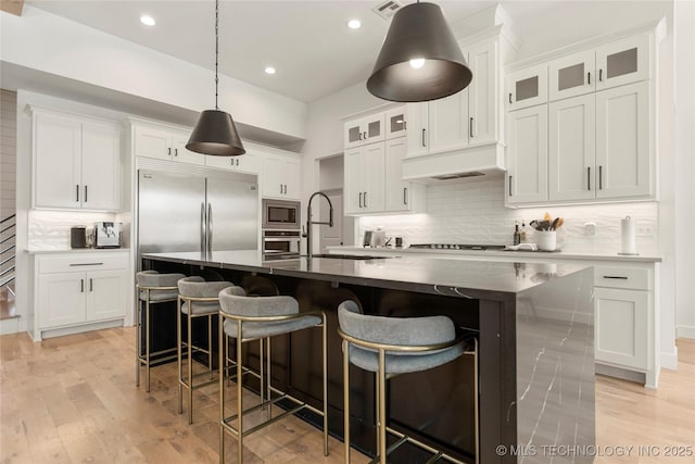 2996 E 142nd Ct S, Bixby, OK 74008 - kitchen featuring a sink, backsplash, dark countertops, and built in appliances