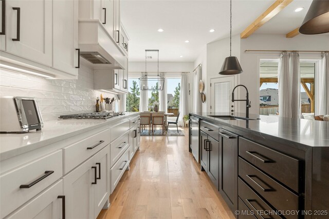 2996 E 142nd Ct S, Bixby, OK 74008 - kitchen with a sink, decorative backsplash, white cabinetry, and custom exhaust hood