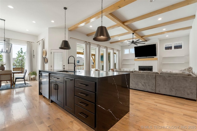 2996 E 142nd Ct S, Bixby, OK 74008 - kitchen with a fireplace, a sink, beam ceiling, and dark countertops