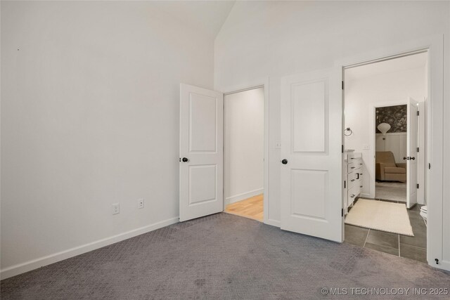 2996 E 142nd Ct S, Bixby, OK 74008 - unfurnished bedroom with a high ceiling, baseboards, and carpet floors