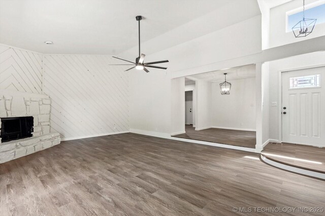 12939 E 34th St, Tulsa, OK 74134 - unfurnished living room with wood finished floors, baseboards, and a stone fireplace