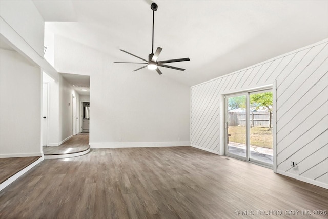 12939 E 34th St, Tulsa, OK 74134 - unfurnished living room with wooden walls, baseboards, a ceiling fan, and wood finished floors
