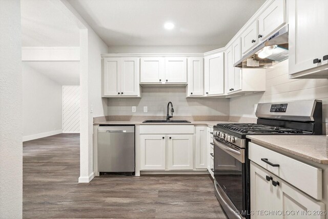 12939 E 34th St, Tulsa, OK 74134 - kitchen featuring white cabinets, a sink, under cabinet range hood, stainless steel appliances, and backsplash