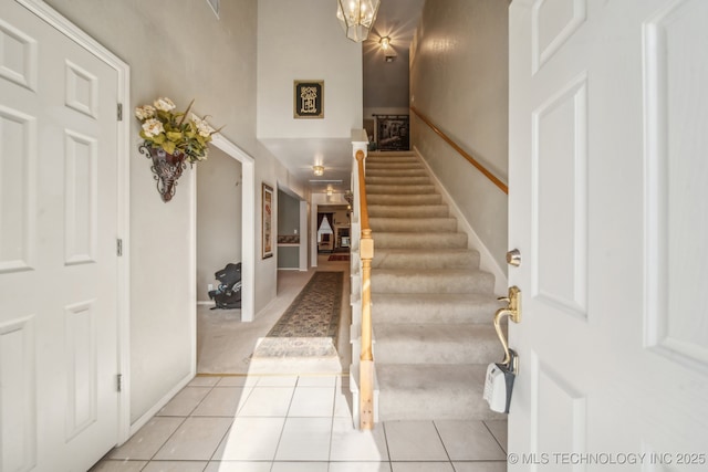 4932 W Commercial St, Broken Arrow, OK 74012 - foyer entrance featuring stairway, light tile patterned floors, and a high ceiling