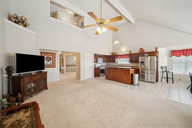 4932 W Commercial St, Broken Arrow, OK 74012 - kitchen with stainless steel appliances, high vaulted ceiling, ceiling fan, a center island, and light colored carpet