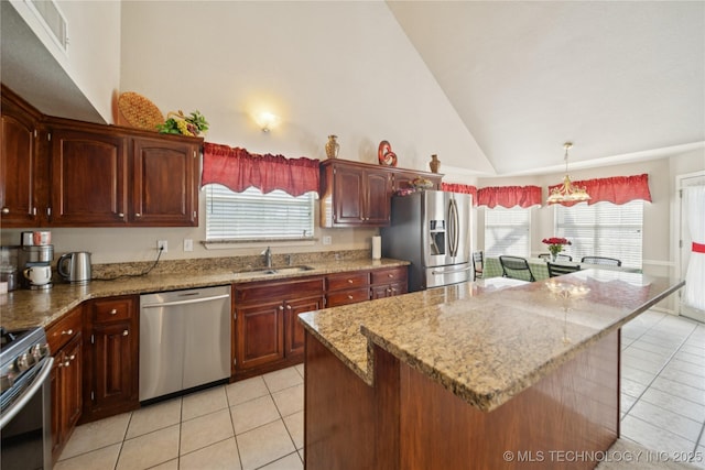 4932 W Commercial St, Broken Arrow, OK 74012 - kitchen with appliances with stainless steel finishes, a sink, light tile patterned flooring, light stone counters, and a center island