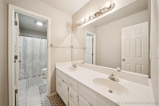 4932 W Commercial St, Broken Arrow, OK 74012 - bathroom with double vanity, toilet, and tile patterned floors