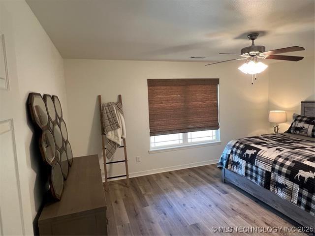 2241 231st St, Buffalo Valley, OK 74571 - bedroom featuring wood finished floors, ceiling fan, baseboards, and visible vents