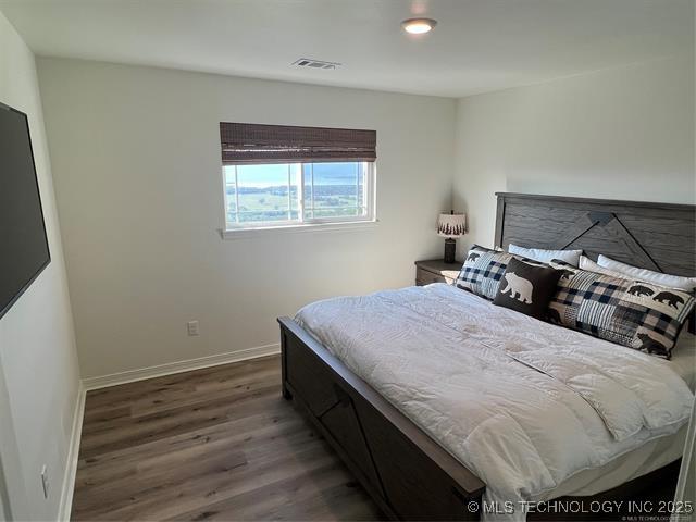 2241 231st St, Buffalo Valley, OK 74571 - bedroom featuring visible vents, baseboards, and wood finished floors
