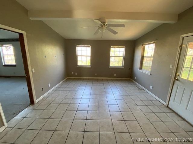 unfurnished room with ceiling fan, plenty of natural light, lofted ceiling with beams, and baseboards