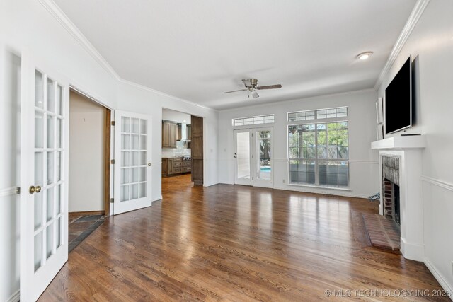 10126 S Granite Ave, Tulsa, OK 74137 - unfurnished living room with french doors, ceiling fan, ornamental molding, a brick fireplace, and dark wood-style flooring