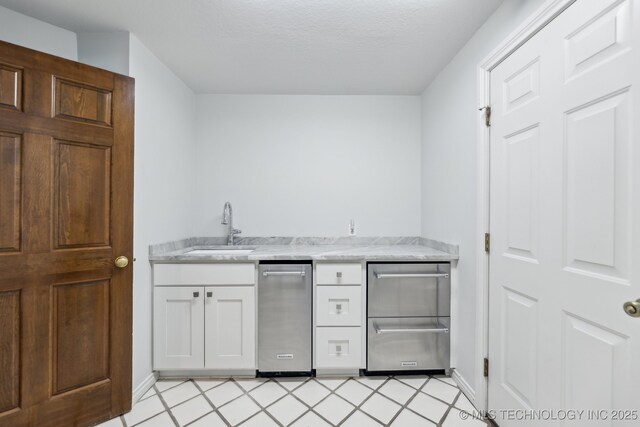 10126 S Granite Ave, Tulsa, OK 74137 - bar area with a sink, baseboards, and a textured ceiling
