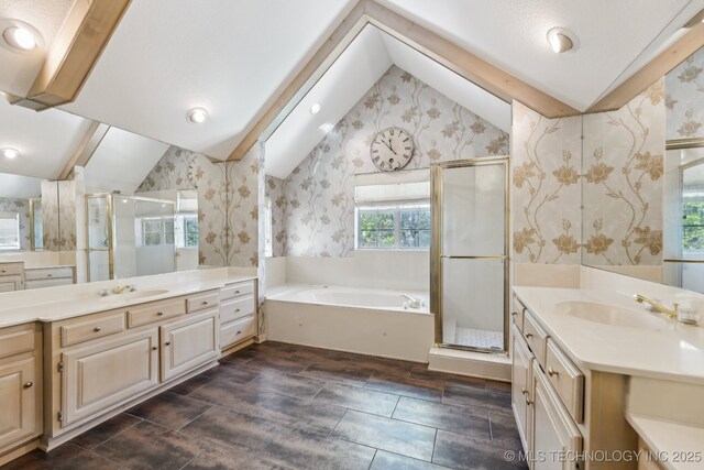10126 S Granite Ave, Tulsa, OK 74137 - full bathroom featuring wallpapered walls, vaulted ceiling, a shower stall, a garden tub, and two vanities