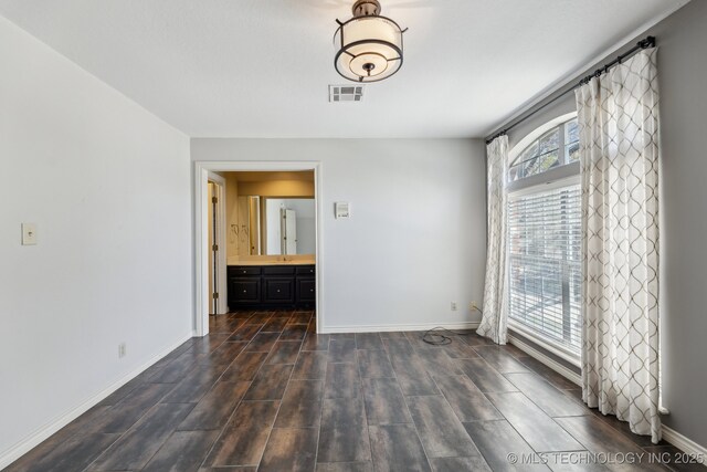 10126 S Granite Ave, Tulsa, OK 74137 - empty room featuring baseboards and dark wood-type flooring