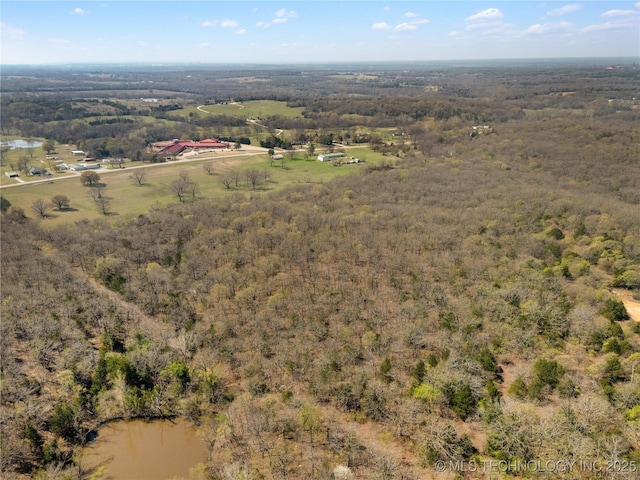 drone / aerial view featuring a view of trees