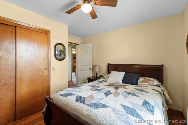 bedroom with a closet, wood finished floors, and ceiling fan