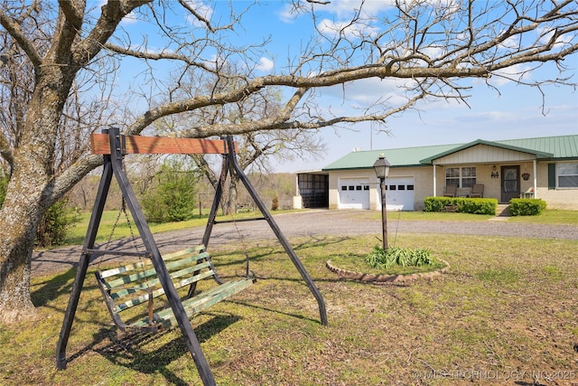 ranch-style house with a garage, a front yard, and driveway