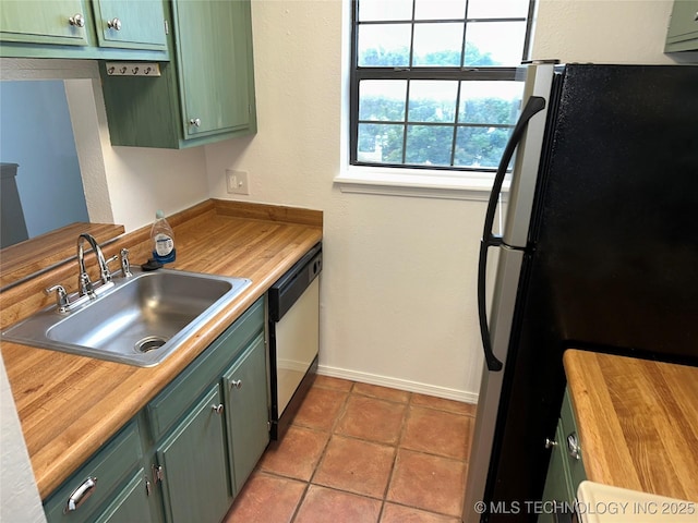 6524 S Memorial Dr Unit 16E, Tulsa, OK 74133 - kitchen with freestanding refrigerator, green cabinets, dishwasher, butcher block counters, and light tile patterned floors