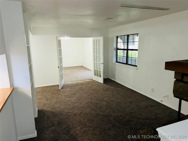 6524 S Memorial Dr Unit 16E, Tulsa, OK 74133 - empty room featuring dark colored carpet and french doors