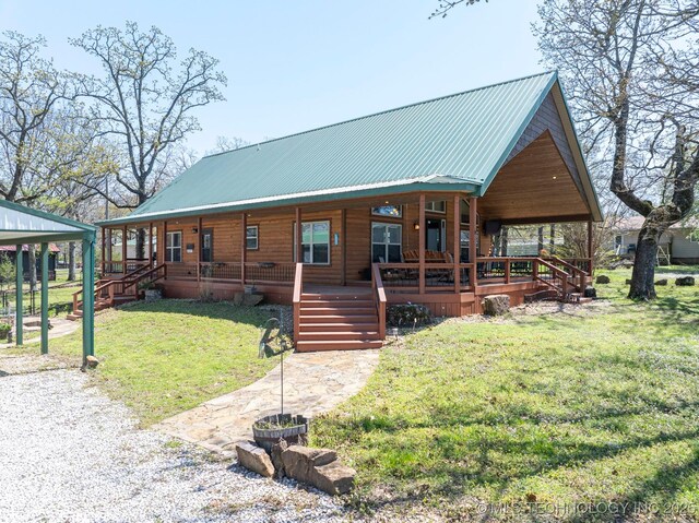 view of front of home with a porch, a front lawn, and metal roof