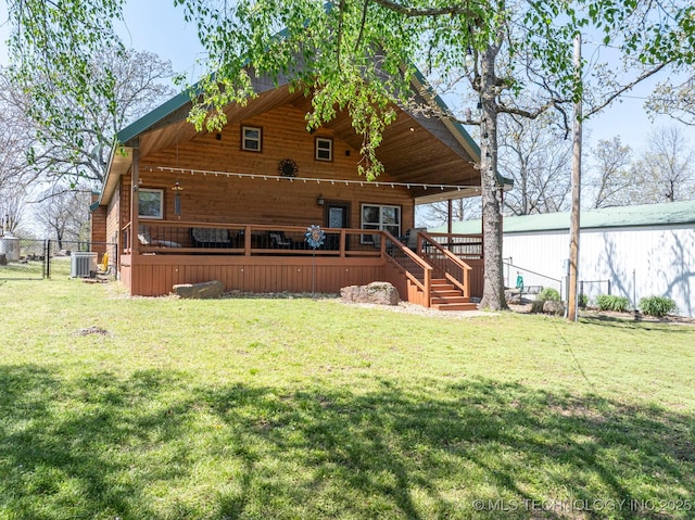 back of house with a lawn, fence, and central AC