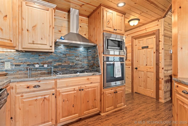 kitchen featuring stainless steel appliances, wooden ceiling, light brown cabinetry, and wall chimney range hood