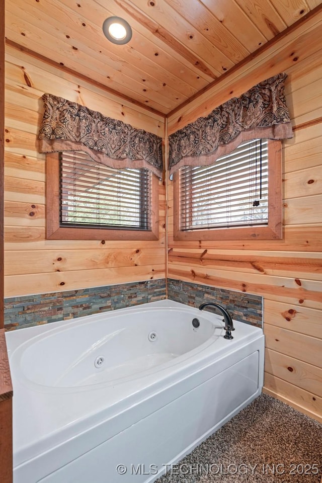 full bath featuring wooden ceiling, wood walls, and a tub with jets