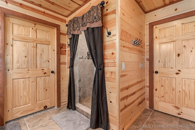 doorway to outside featuring wood walls, tile patterned floors, and wooden ceiling