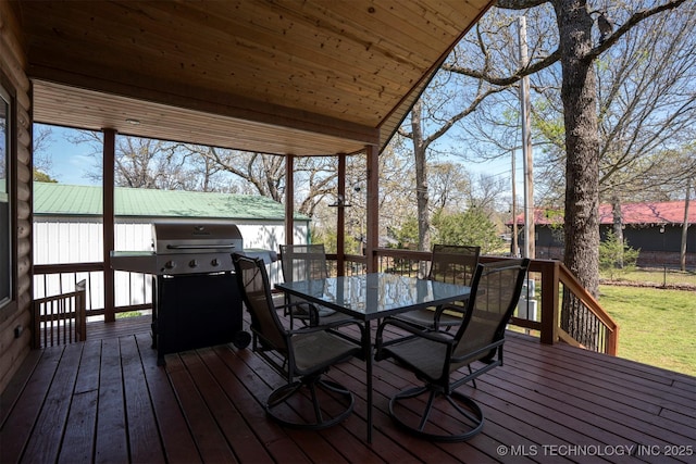 wooden deck with grilling area and outdoor dining space