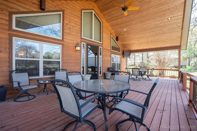 wooden terrace with a ceiling fan and outdoor dining area