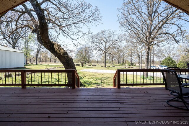 wooden terrace with a yard