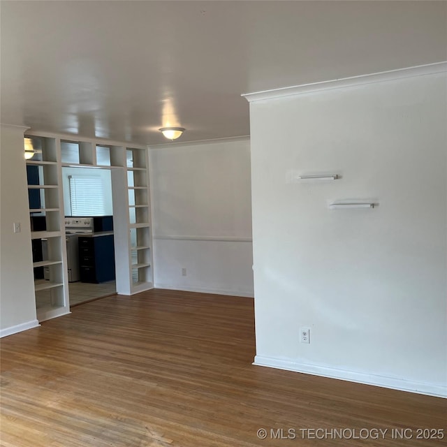 spare room with wood finished floors and baseboards