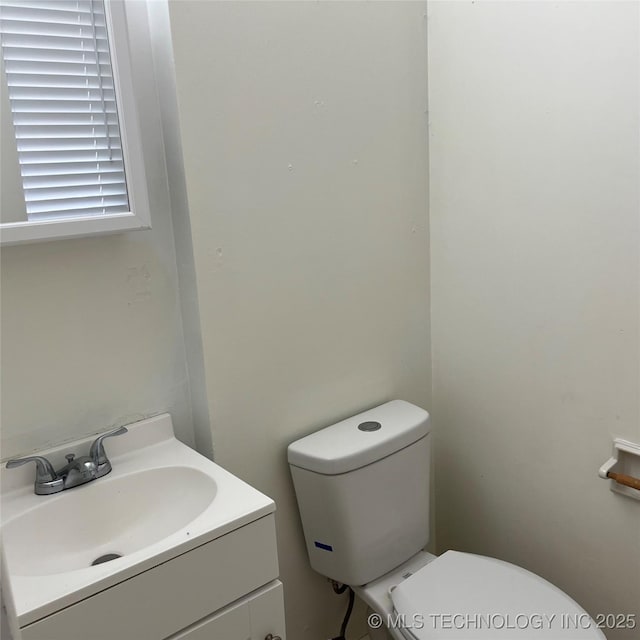 bathroom with toilet and vanity