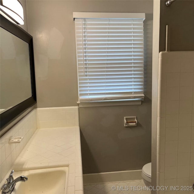 full bath featuring a sink, toilet, and tile patterned flooring