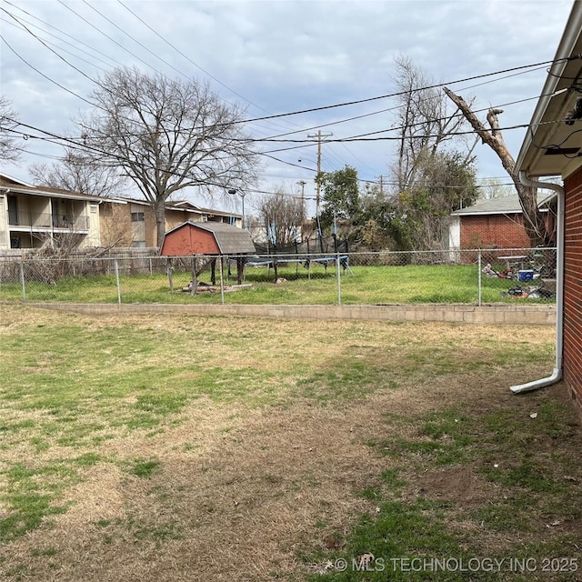 view of yard featuring a fenced backyard and a trampoline