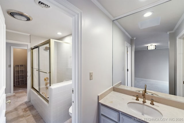 full bathroom with bath / shower combo with glass door, toilet, vanity, and crown molding